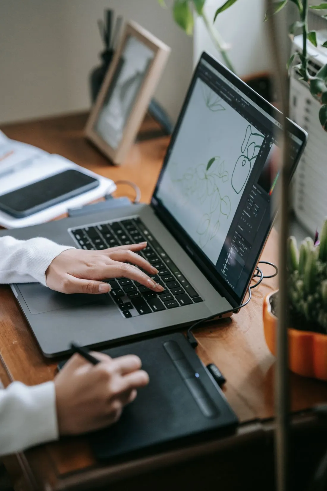 A person works on an illustration at their desk.